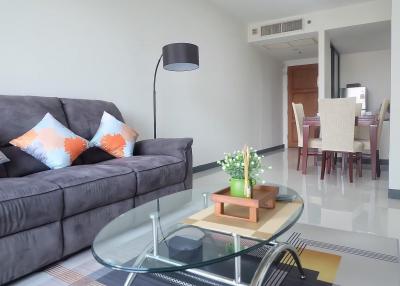 Cozy and modern living room with dining area in the background