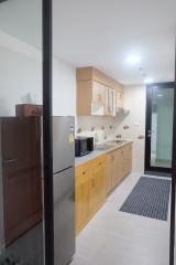 Modern kitchen interior with wooden cabinets and stainless steel appliances