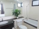 Modern bathroom with bathtub and houseplant on the counter