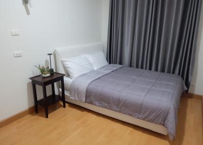 Cozy bedroom with a double bed and stylish grey curtains