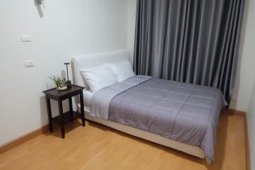 Cozy bedroom with a double bed and stylish grey curtains