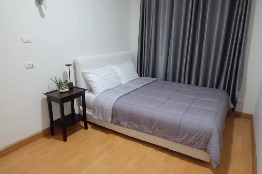 Cozy bedroom with a double bed and stylish grey curtains