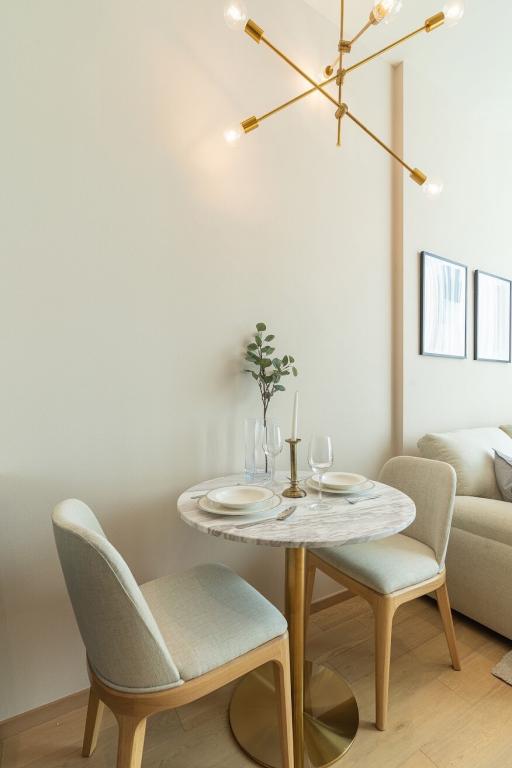 Modern minimalist dining area with round table and comfortable chairs