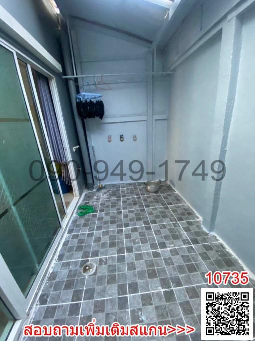 Enclosed balcony or utility space with tiled floor and glass sliding door