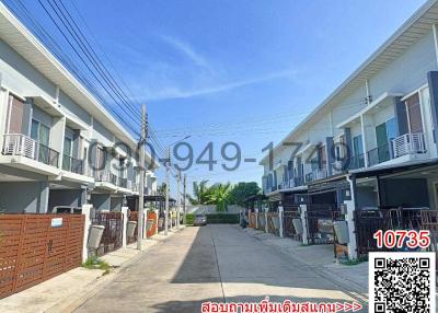 Exterior view of modern residential townhouses with clear blue sky