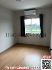 Spacious bedroom with air conditioning unit and large window