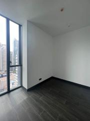 Empty modern bedroom with large window and city view