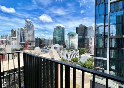 Spacious balcony with a panoramic city view and clear skies