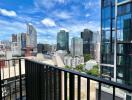 Spacious balcony with a panoramic city view and clear skies