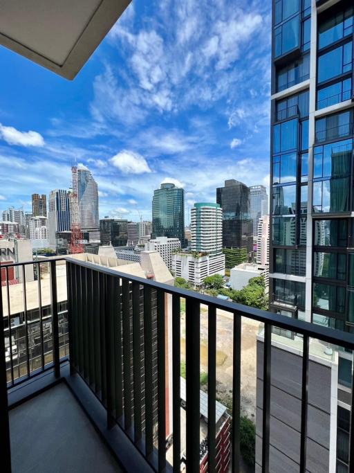 Spacious balcony with a panoramic city view and clear skies