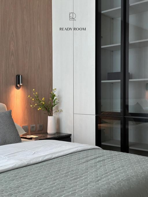 Modern bedroom interior with ready room signage, a cozy bed, and elegant decor