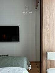 Modern bedroom with wall-mounted TV and minimalistic design