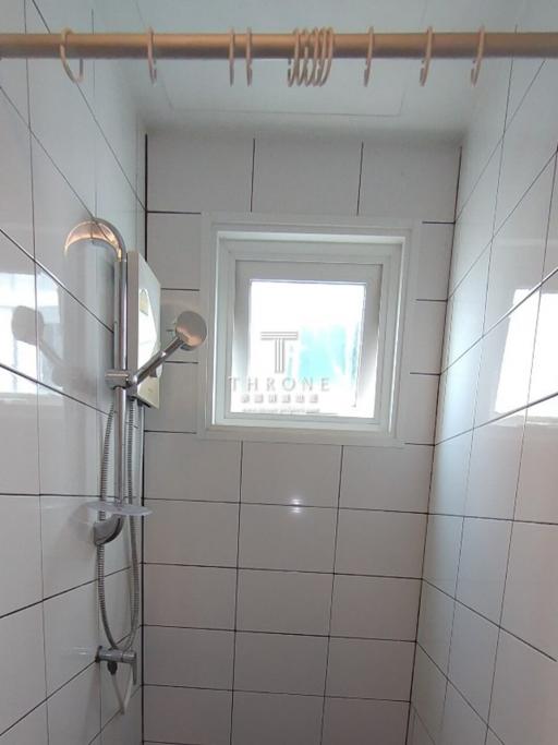 Modern bathroom with a walk-in shower and tiled walls