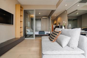 Spacious and modern living room with an open view towards the bedroom