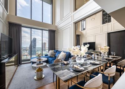 Modern living room with dining area and panoramic city view through large windows