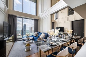 Modern living room with dining area and panoramic city view through large windows