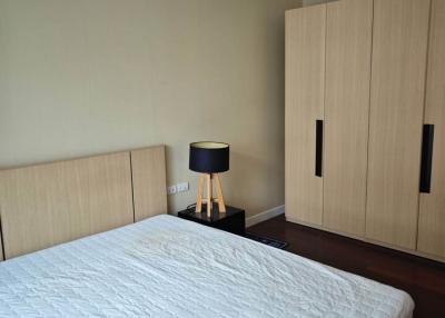 Modern bedroom interior with king-sized bed and wooden wardrobe