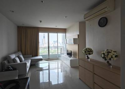 Spacious living room with natural light and modern furnishings