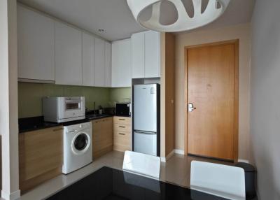 Modern kitchen with wooden cabinets and integrated appliances