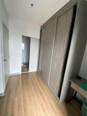 Compact bedroom with large wardrobe and wooden flooring