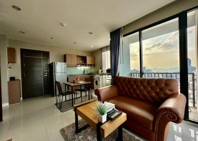 Modern living room with open kitchen and city view