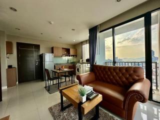 Modern living room with open kitchen and city view