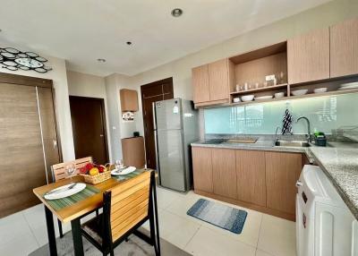 Modern kitchen with wooden cabinetry and dining area