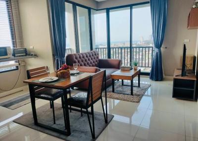 Elegant living room with dining area and city view