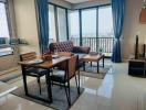 Elegant living room with dining area and city view