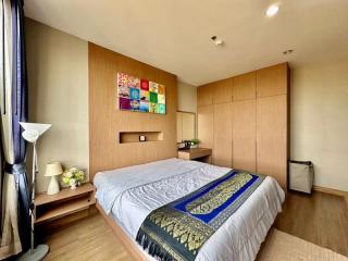 Modern bedroom with wooden wall paneling and colorful artwork