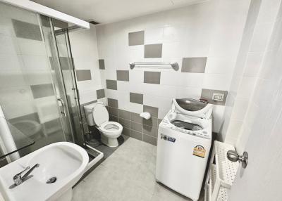 Modern bathroom interior with white fixtures and washing machine