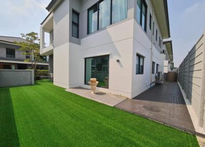 Modern two-story house with artificial lawn and exterior finishes