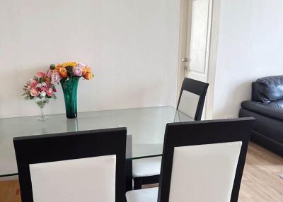 Modern dining area with table set and flowers