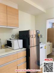 Modern kitchen with stainless steel refrigerator and white appliances