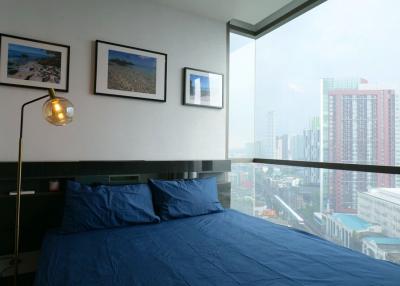 Modern bedroom with large window overlooking the city