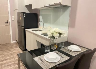 Modern kitchen with dining area, stainless steel appliances and wooden flooring