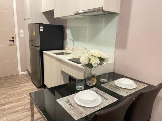 Modern kitchen with dining area, stainless steel appliances and wooden flooring