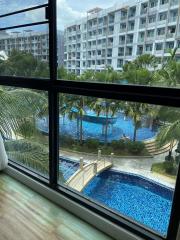 Panoramic view from a room showcasing the swimming pool and the surrounding apartment complex