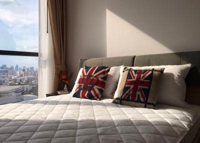 Cozy bedroom with a city view and decorative throw pillows