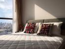 Cozy bedroom with a city view and decorative throw pillows