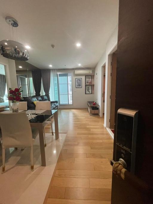 Modern living and dining area with an open layout, tiled flooring, and natural lighting