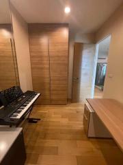 Hallway interior with wooden floor, wardrobe, and a piano