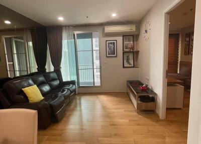 Spacious living room with wooden flooring and modern furnishings