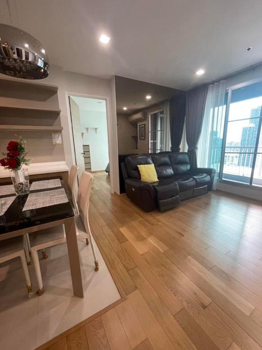 Cozy living room with dining area and balcony access