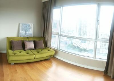 Bright living room with large window views and a green sofa