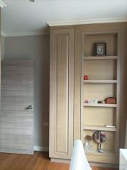Modern bedroom interior with wooden wardrobe and shelving