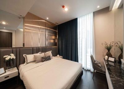 Modern bedroom interior with a comfortable double bed, elegant decor, and natural light