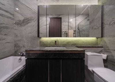 Modern bathroom with marble walls and underlit sink