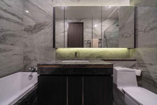 Modern bathroom with marble walls and underlit sink