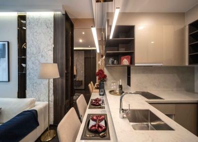 Modern kitchen with marble countertops and integrated living space